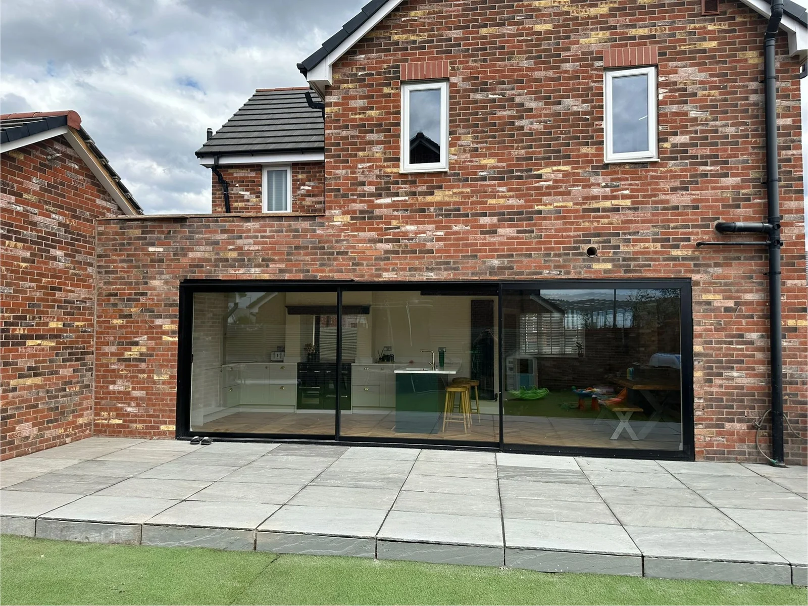 Completed rear house extension with brickwork and large glazing in Manchester